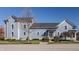 Charming light blue two-story home with a well-maintained front yard and a dark roof at 12895 Grenville St, Carmel, IN 46032