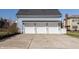 Features a three car garage with white doors, and a blue house exterior at 12895 Grenville St, Carmel, IN 46032