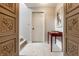 Hallway featuring carpet flooring, a door, console table, and decorative accents at 12895 Grenville St, Carmel, IN 46032