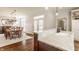 Bright kitchen with custom cabinets, stainless steel appliances, island, hardwood floors and sink at 12895 Grenville St, Carmel, IN 46032