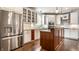 Stylish kitchen with white cabinets, stainless steel refrigerator, center island, and modern appliances at 12895 Grenville St, Carmel, IN 46032