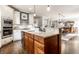 Kitchen featuring island, sink, stainless steel dishwasher and appliances, granite counter tops, and hardwood floors at 12895 Grenville St, Carmel, IN 46032