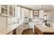 Bright kitchen with custom cabinets, stainless steel appliances, island and hardwood floors at 12895 Grenville St, Carmel, IN 46032