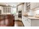 Well-lit kitchen with white cabinetry, stainless steel appliances, stone countertops, and hardwood floors at 12895 Grenville St, Carmel, IN 46032