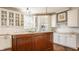Bright kitchen with custom cabinets, stainless steel appliances, and an island at 12895 Grenville St, Carmel, IN 46032