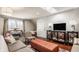 Well-lit living room boasting a skylight, entertainment center, and comfortable seating arrangement at 12895 Grenville St, Carmel, IN 46032