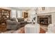 Comfortable living room featuring a fireplace, a cozy couch, an ottoman, and built-in bookshelves at 12895 Grenville St, Carmel, IN 46032