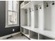 Mudroom with gray walls, white cubbies, hooks, and a window, perfect for organization at 12895 Grenville St, Carmel, IN 46032