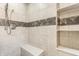 Tiled shower with bench and recessed shelves, featuring chrome shower head at 12895 Grenville St, Carmel, IN 46032