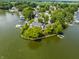 Aerial view of a lakefront community featuring manicured lawns, private docks, and luxurious waterfront living at 1326 White Water Ct, Cicero, IN 46034