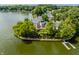 Aerial view of a waterfront estate with a private dock surrounded by lush landscaping at 1326 White Water Ct, Cicero, IN 46034