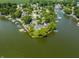 Stunning aerial view of luxury waterfront home, private boat docks, and lush landscaping at 1326 White Water Ct, Cicero, IN 46034