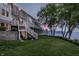 Exterior backyard shot of home with tiered decks and manicured lawn overlooking lake at 1326 White Water Ct, Cicero, IN 46034