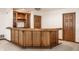 Finished basement with wooden wet bar, shelving, wine rack and granite countertops at 1326 White Water Ct, Cicero, IN 46034