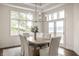 Bright dining room featuring a wood table, seating for six, and French doors to the outside at 1326 White Water Ct, Cicero, IN 46034