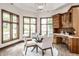 Bright dining nook with water view, built-in desk, and a glass table with seating for four at 1326 White Water Ct, Cicero, IN 46034