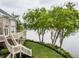 Beautifully landscaped property with a deck and stairs leading to breathtaking lake views at 1326 White Water Ct, Cicero, IN 46034