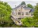 Expansive brick home features a spacious deck, outdoor seating, and beautiful landscaping at 1326 White Water Ct, Cicero, IN 46034