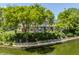 Waterfront home featuring a lakeside view, outdoor seating, mature trees, and a multi-tiered deck at 1326 White Water Ct, Cicero, IN 46034