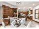 Open concept kitchen with wood cabinets and stainless steel appliances, flowing into a dining area at 1326 White Water Ct, Cicero, IN 46034