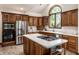 Spacious kitchen with wood cabinets, granite countertops, stainless steel appliances, and a center island at 1326 White Water Ct, Cicero, IN 46034