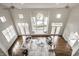 Top-down view of an open-concept living room with stylish decor and large windows showcasing serene lake views at 1326 White Water Ct, Cicero, IN 46034