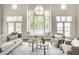 Bright and spacious living room with large windows offering picturesque lake views and abundant natural light at 1326 White Water Ct, Cicero, IN 46034