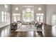 Elegant living room featuring stylish furnishings, hardwood floors, and expansive windows with scenic lake views at 1326 White Water Ct, Cicero, IN 46034