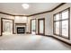 Spacious main bedroom featuring a fireplace, multiple windows, and entryways to a seating area and bath at 1326 White Water Ct, Cicero, IN 46034