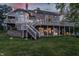 Rear exterior view of home featuring tiered decks, patio, and lake views at 1326 White Water Ct, Cicero, IN 46034