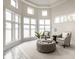 Bright sitting area with views of the lake, and features an ottoman and two chairs at 1326 White Water Ct, Cicero, IN 46034