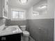 Standard bathroom with a single sink vanity and tiled walls at 1327 E Minnesota St, Indianapolis, IN 46203