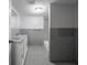 Full bathroom with double sink vanity, bathtub, and tiled walls at 1327 E Minnesota St, Indianapolis, IN 46203