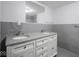 Bathroom featuring a double vanity with granite countertops and large mirror at 1327 E Minnesota St, Indianapolis, IN 46203