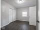 Comfortable bedroom with closet space, neutral walls, and dark gray flooring at 1327 E Minnesota St, Indianapolis, IN 46203