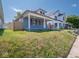 A quaint single-Gathering home with a welcoming front porch, set against a backdrop of a sunny day at 1327 E Minnesota St, Indianapolis, IN 46203