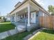 Charming covered porch with wooden deck and white columns, enhancing the curb appeal of this inviting home at 1327 E Minnesota St, Indianapolis, IN 46203