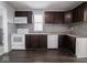Clean kitchen featuring white appliances and dark wood cabinets at 1327 E Minnesota St, Indianapolis, IN 46203