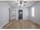 Bright living room with hardwood floors and a vintage ceiling fan at 1327 E Minnesota St, Indianapolis, IN 46203