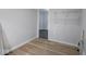 Room featuring hardwood flooring and empty shelving at 1327 E Minnesota St, Indianapolis, IN 46203