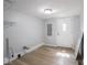 Unfurnished room with hardwood flooring and a door at 1327 E Minnesota St, Indianapolis, IN 46203