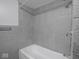 Tiled shower featuring a shower head and gray tiling at 1327 E Minnesota St, Indianapolis, IN 46203