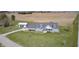 An aerial view of a charming two-story home with a gray exterior, long driveway, and detached garage at 1502 W 525 N, Lebanon, IN 46052
