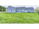 Backyard of a home with a green lawn, blue siding, and mature trees at 1502 W 525 N, Lebanon, IN 46052