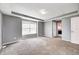 Large primary bedroom offering plush carpeting, a bright window, and seamless access to the en-suite bathroom at 1502 W 525 N, Lebanon, IN 46052