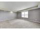 Bright bedroom with neutral carpet, gray walls, white trim, and a large window for ample natural light at 1502 W 525 N, Lebanon, IN 46052