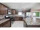 Beautiful kitchen with dark wood cabinets, stainless steel appliances, an island, and tile flooring at 1502 W 525 N, Lebanon, IN 46052