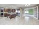 Well-equipped kitchen with dark wood cabinets, stainless steel appliances, tile flooring, and adjacent breakfast nook at 1502 W 525 N, Lebanon, IN 46052