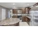Well-equipped kitchen with dark wood cabinets, stainless steel appliances, an island, and tile flooring at 1502 W 525 N, Lebanon, IN 46052