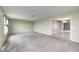 Open living room with a seamless flow to the dining area, featuring plush carpeting and bright, neutral paint at 1502 W 525 N, Lebanon, IN 46052